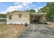 Charming single story home boasting a covered carport and an airy, spacious front yard at 36912 Skycrest Blvd, Fruitland Park, FL 34731