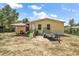 Charming home exterior featuring a covered entrance and surrounding greenery at 36912 Skycrest Blvd, Fruitland Park, FL 34731