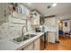 Bright kitchen featuring stainless steel appliances, crisp white cabinets, and a stainless steel sink at 36912 Skycrest Blvd, Fruitland Park, FL 34731