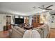 Spacious living room with a large screen television, fireplace, and comfortable sectional sofa at 36912 Skycrest Blvd, Fruitland Park, FL 34731