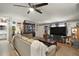 Inviting living room featuring a plush sofa, large TV, and ample natural light for comfortable living at 36912 Skycrest Blvd, Fruitland Park, FL 34731