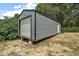 Durable metal shed with a roll-up door, offering secure storage space at 36912 Skycrest Blvd, Fruitland Park, FL 34731