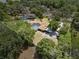 Aerial view of the property with a screened pool and lush trees at 3805 Gaines Dr, Winter Haven, FL 33884