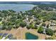 Aerial view of a home in a serene, wooded neighborhood near a lake at 3805 Gaines Dr, Winter Haven, FL 33884