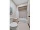Classic bathroom with tub/shower, white toilet, and decorative wallpaper at 3805 Gaines Dr, Winter Haven, FL 33884