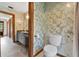 Bright bathroom features a vanity, toilet, and floral wallpaper at 3805 Gaines Dr, Winter Haven, FL 33884