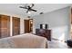 Comfortable bedroom features neutral walls, ceiling fan, and tile flooring at 3805 Gaines Dr, Winter Haven, FL 33884