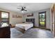 A cozy bedroom featuring a queen bed with a wood frame, tile floors, and a ceiling fan at 3805 Gaines Dr, Winter Haven, FL 33884