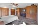 Spacious bedroom featuring wood walls, tile floors, and a ceiling fan at 3805 Gaines Dr, Winter Haven, FL 33884