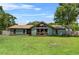 Inviting single-story home featuring a large front yard, complemented by a unique architectural design with plentiful windows at 3805 Gaines Dr, Winter Haven, FL 33884