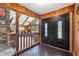 Inviting foyer featuring a beautiful double door, wood paneling, brick accents, and views into the spacious, bright living room at 3805 Gaines Dr, Winter Haven, FL 33884