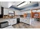 The open kitchen has granite countertops and stone backsplash, seamlessly connecting to the dining area at 3805 Gaines Dr, Winter Haven, FL 33884