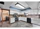 Bright kitchen equipped with modern appliances, granite counters, and a stone backsplash under a skylight at 3805 Gaines Dr, Winter Haven, FL 33884