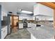 Well-lit kitchen features white cabinets, granite countertops, stainless steel appliances, and stylish stone backsplash at 3805 Gaines Dr, Winter Haven, FL 33884