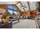 Bright living room boasts wood paneling, lots of natural light, a vaulted ceiling, and lots of space for entertaining at 3805 Gaines Dr, Winter Haven, FL 33884