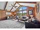 Bright living room featuring wood paneling, vaulted ceilings, large windows, and a plush carpet, offering style and comfort at 3805 Gaines Dr, Winter Haven, FL 33884