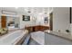 Bright main bathroom boasting a soaking tub, and dual sinks with wood cabinets at 3805 Gaines Dr, Winter Haven, FL 33884