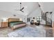 Spacious main bedroom featuring a spiral staircase and comfortable sitting area at 3805 Gaines Dr, Winter Haven, FL 33884