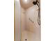 Close up of a glass enclosed shower with grab bar and hexagon tile floor at 3805 Gaines Dr, Winter Haven, FL 33884