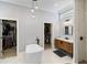 Stylish bathroom with a freestanding tub, dual walk-in closets, and natural light at 3812 Cheverly E Dr, Lakeland, FL 33813