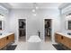 Large bathroom featuring dual vanities, a soaking tub, and -and- walk-in closets at 3812 Cheverly E Dr, Lakeland, FL 33813