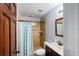 Bathroom featuring tile floors, a single sink vanity, and a tiled shower with glass door at 3812 Cheverly E Dr, Lakeland, FL 33813