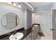 Clean bathroom featuring double sinks, granite countertops, and modern fixtures at 3812 Cheverly E Dr, Lakeland, FL 33813
