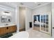 Modern bathroom with a large vanity, glass-enclosed shower, and doorway to a bedroom at 3812 Cheverly E Dr, Lakeland, FL 33813