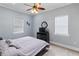 Relaxing bedroom with a ceiling fan, plush carpet, and great natural light at 3812 Cheverly E Dr, Lakeland, FL 33813