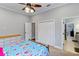 Bedroom features a ceiling fan, closet, and an ensuite bathroom at 3812 Cheverly E Dr, Lakeland, FL 33813