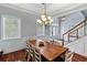 Bright dining room boasts hardwood floors, wainscoting, and an elegant chandelier at 3812 Cheverly E Dr, Lakeland, FL 33813