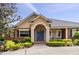 Attractive home with brick accents, blue front door, and meticulously landscaped front yard at 3812 Cheverly E Dr, Lakeland, FL 33813