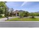 Charming single-story home with well-manicured lawn, rock landscaping, and brick accents offers curb appeal at 3812 Cheverly E Dr, Lakeland, FL 33813