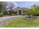 Charming home with well-manicured lawn, mature trees, and welcoming blue front door at 3812 Cheverly E Dr, Lakeland, FL 33813