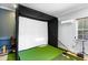 Golf simulator room with artificial turf and golf training equipment at 3812 Cheverly E Dr, Lakeland, FL 33813
