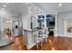 Modern kitchen features stainless steel appliances, a central island with seating, and elegant hardwood floors at 3812 Cheverly E Dr, Lakeland, FL 33813
