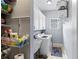 Well-organized laundry room with shelving, cabinets, washer, dryer, and sink at 3812 Cheverly E Dr, Lakeland, FL 33813