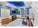 Bright living room with a blue accent wall, hardwood floors, and lots of natural light at 3812 Cheverly E Dr, Lakeland, FL 33813