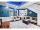 Bright living room with hardwood floors, wainscotting, and an eye-catching blue accent wall at 3812 Cheverly E Dr, Lakeland, FL 33813