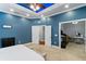 Spacious main bedroom with a unique ceiling fan and decorative tray ceiling at 3812 Cheverly E Dr, Lakeland, FL 33813