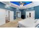 Spacious main bedroom with stylish tray ceiling lighting, neutral carpet, and access to ensuite bathroom at 3812 Cheverly E Dr, Lakeland, FL 33813