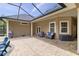 Paver patio with outdoor seating, adjacent to the screened pool area at 3812 Cheverly E Dr, Lakeland, FL 33813