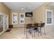 Outdoor covered patio with ceiling fan, TV, and bar-height seating at 3812 Cheverly E Dr, Lakeland, FL 33813