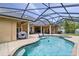 Inviting pool area with screened enclosure, spa, brick patio, outdoor kitchen and ample space for entertaining at 3812 Cheverly E Dr, Lakeland, FL 33813