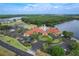 Aerial shot of community clubhouse and pool area overlooking pond and tree-lined horizon at 3852 Serenade Ln, Lakeland, FL 33811