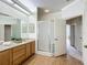 Bathroom featuring a vanity, a mirror and a framed shower with a glass door at 3852 Serenade Ln, Lakeland, FL 33811