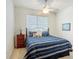 Bedroom features striped bedding, ceiling fan, and a window with blinds at 3852 Serenade Ln, Lakeland, FL 33811