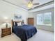Cozy bedroom with a tray ceiling, ceiling fan, and a bright window at 3852 Serenade Ln, Lakeland, FL 33811