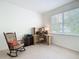 Bright bedroom with large window, neutral carpet, and a comfortable rocking chair at 3852 Serenade Ln, Lakeland, FL 33811