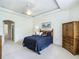 Serene bedroom featuring a tray ceiling, ceiling fan, and ample natural light at 3852 Serenade Ln, Lakeland, FL 33811